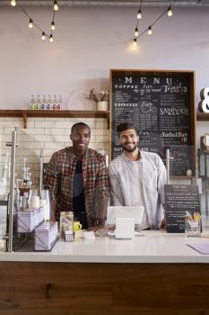 Business partners at the counter of a coffee shop, vertical