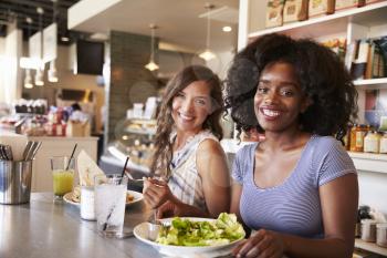 Two Women Enjoying Lunch Date In Delicatessen Restaurant