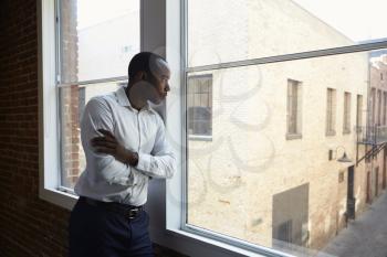Businessman Standing By Office Window