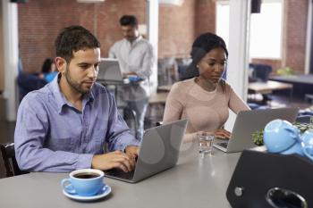 Businesspeople Working On Laptops In Office Coffee Bar