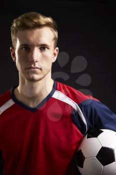 Portrait Of Professional Soccer Player With Ball In Studio