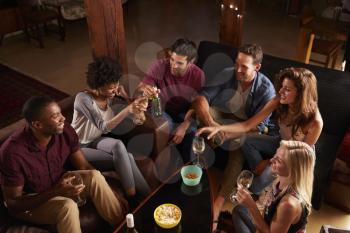 Young adults socialising at a party at home, elevated view