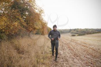 Mature Man Running Around Autumn Field