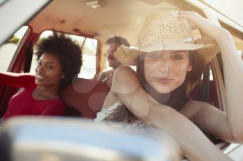 Portrait Of Friends Relaxing In Car During Road Trip