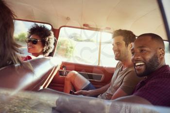 Group Of Friends Relaxing In Car During Road Trip