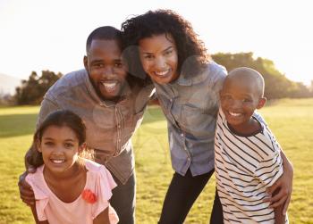Portrait of smiling black family looking to camera outdoors