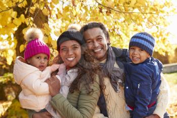 Outdoor Portrait Of Family In Autumn Landscape