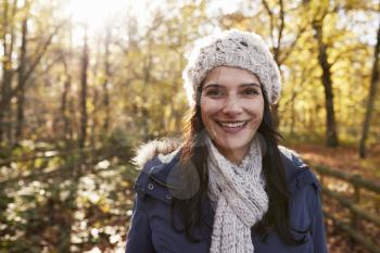 Portrait Of Attractive Woman On Walk In Autumn Countryside
