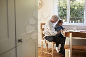 Grandfather And Granddaughter Colouring Picture Together