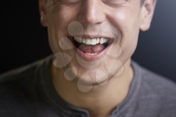 Cropped portrait of a laughing young white man