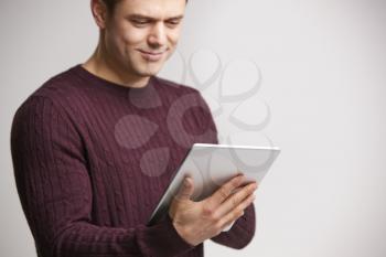 Smiling young white man using a tablet computer