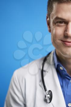 Smiling white male doctor with stethoscope, vertical, crop