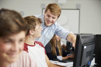 Teenage Students Studying In IT Class With Teacher