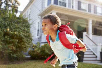Young Boy Leaving House To Walk To School