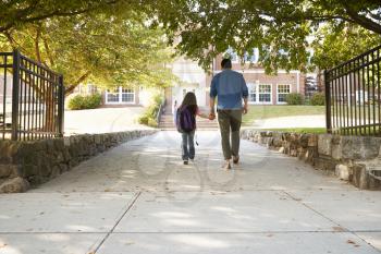 Father Dropping Off Daughter In Front Of School Gates