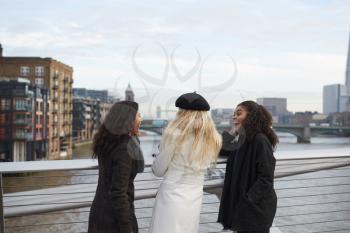 Rear View Of Female Friends Visiting London In Winter