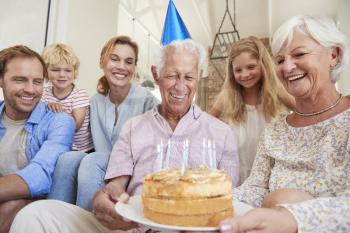 Multi generation family celebrating grandads birthday
