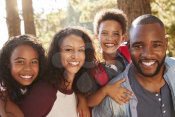 Portrait Of Family On Hiking Adventure Through Woods