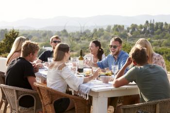 Group Of Young Friends Enjoying Outdoor Meal On Holiday