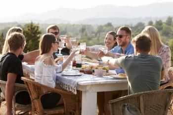 Group Of Young Friends Enjoying Outdoor Meal On Holiday