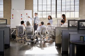 Young male manager using whiteboard in a business meeting