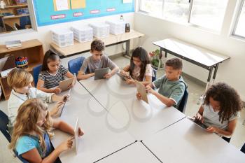 Young kids using tablets in school lesson, elevated view