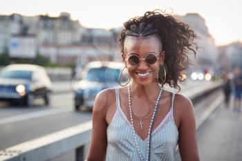 Trendy woman in striped camisole and sunglasses, portrait