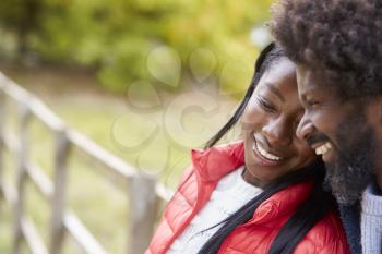 Smiling mature black couple together in the ocuntryside, close up