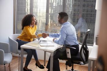 Woman Shaking Hands At Meeting With Male Financial Advisor Relationship Counsellor In Office