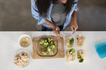 Overhead View Of Woman In Kitchen Preparing High Protein Meal