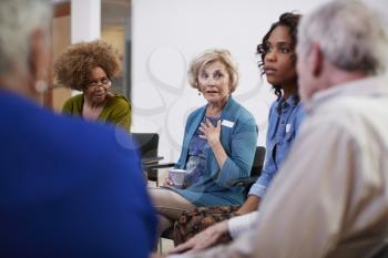 People Attending Self Help Therapy Group Meeting In Community Center