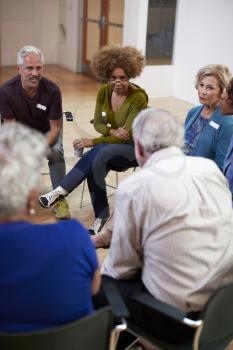 People Attending Self Help Therapy Group Meeting In Community Center