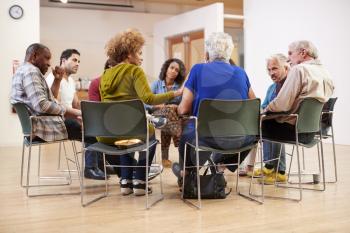 People Attending Self Help Therapy Group Meeting In Community Center