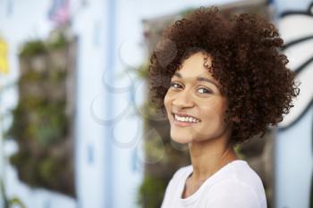 Outdoor Head And Shoulders Portrait Of Smiling Young Woman