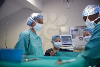 Surgical Team Working On Patient In Hospital Operating Theatre