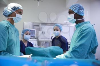 Surgical Team Working On Patient In Hospital Operating Theatre