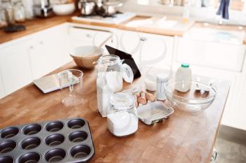 Ingredients And Baking Utensils Laid Out On Work Surface In Kitchen