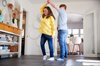 Young Downs Syndrome Couple Having Fun Dancing At Home Together