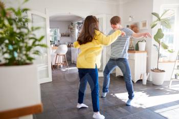 Young Downs Syndrome Couple Having Fun Dancing At Home Together