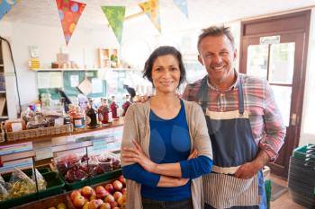 Portrait Of Mature Couple Running Organic Farm Shop Together