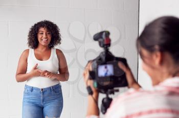 Female Videographer Recording Woman Recording Podcast In Studio