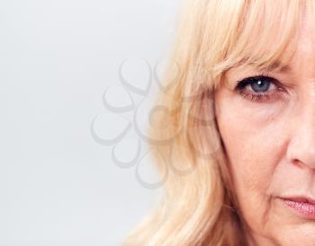 Studio Close Up Of Mature Woman Looking Suspicious And Distrustful