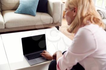 Mature Woman Having Online Consultation With Doctor At Home On Laptop Computer