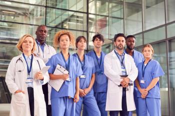 Portrait Of Serious Medical Team Standing In Modern Hospital Building