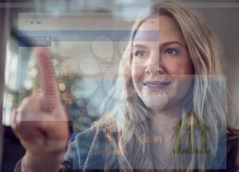 View From Behind Mobile Screen As Woman Transfers Money From Bank Account At Christmas