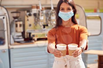 Woman Wearing Face Mask Running Mobile Coffee Shop Holding Takeaway Cups Outdoors Next To Van