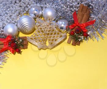 Royalty Free Photo of Christmas Decorations on a Bright Yellow Background