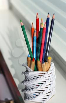 Colored pencils in a paper cup