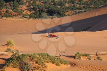 Reserve Coral sand dunes in the U.S..Red car for driving on sand

