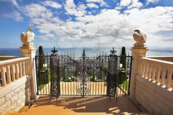 Charming architectural ensemble in Bahai gardens: a survey ground
 from a red marble and graceful black iron-barred